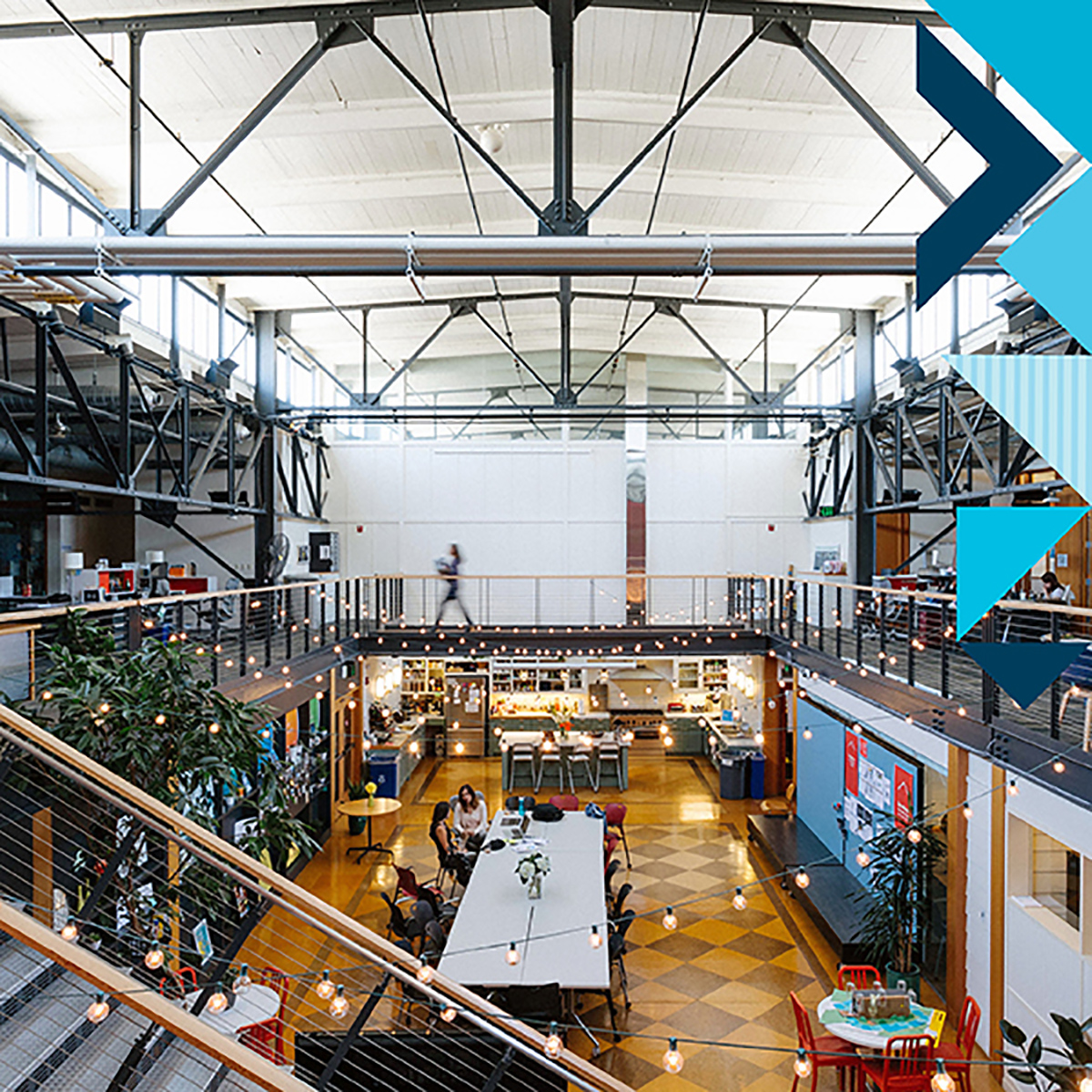 The interior of a Capital One workspace, with string lights, a kitchen break area, and an open work concept